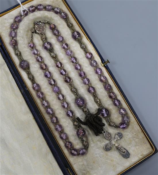 An early 20th French amethyst bead necklace, with white metal cross pendant drop, approx. 90cm.